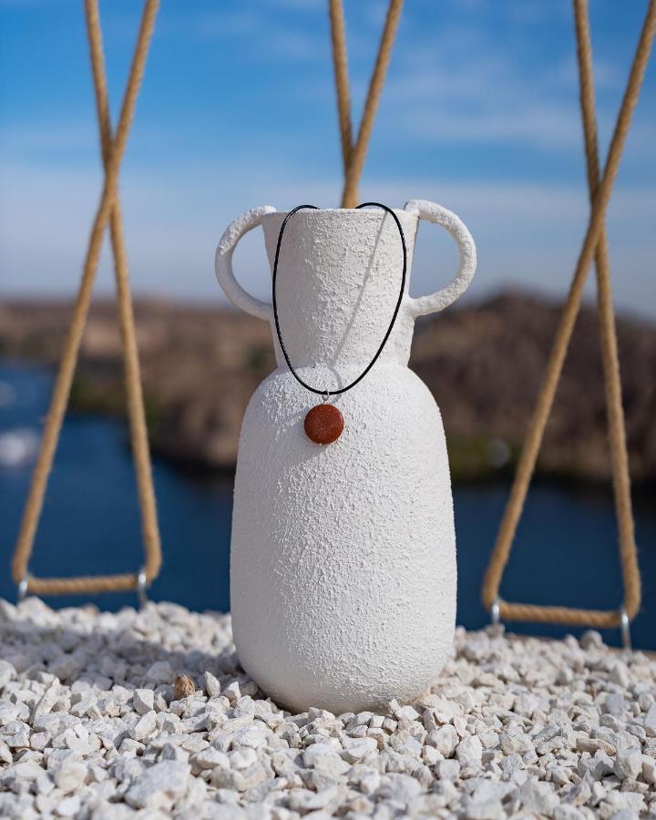 Benben By Dhara Hotels - Adults Only Aswan Bagian luar foto A necklace with a pendant