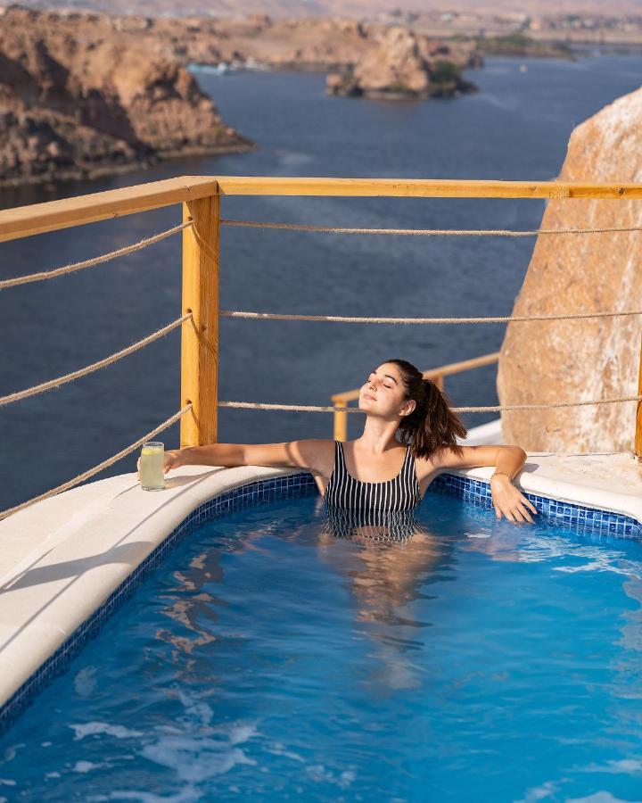 Benben By Dhara Hotels - Adults Only Aswan Bagian luar foto A woman relaxing in a swimming pool